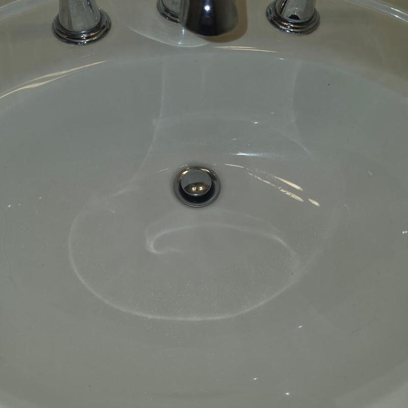 Bathroom sink drain and faucet fixture close-up