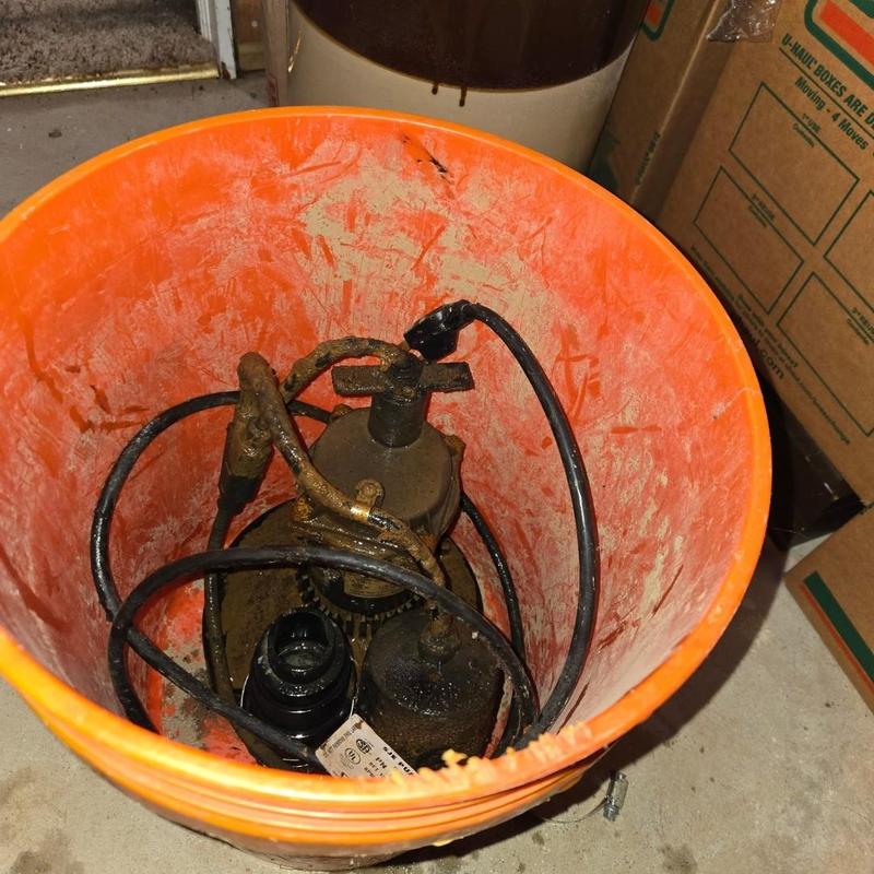 Sump pump and check valve in orange bucket