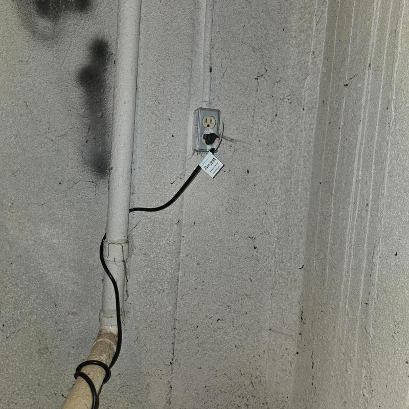 Sump pump power connection on basement wall
