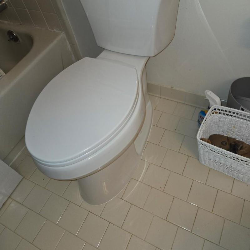 Toilet replacement in bathroom with tiled floor