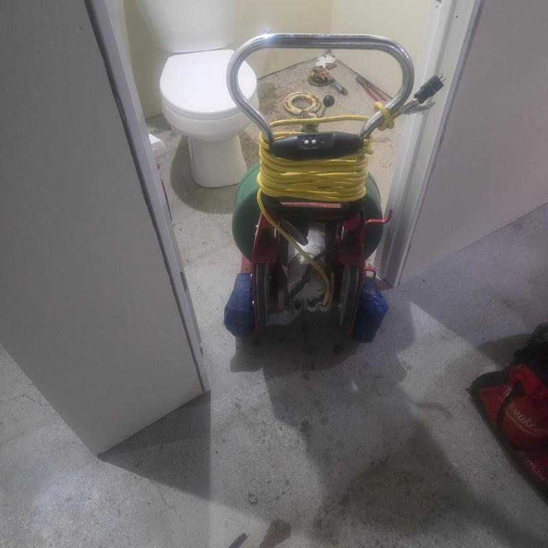 Toilet flange and underfloor drain cleaning equipment setup