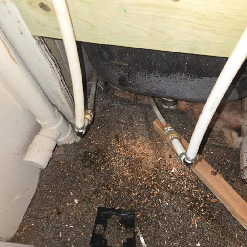 Shower valve pipes under bathtub with clamp fittings