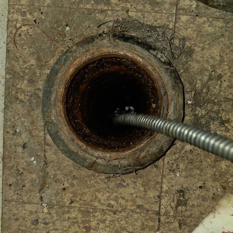 Basement cleanout drain cable removing root obstruction