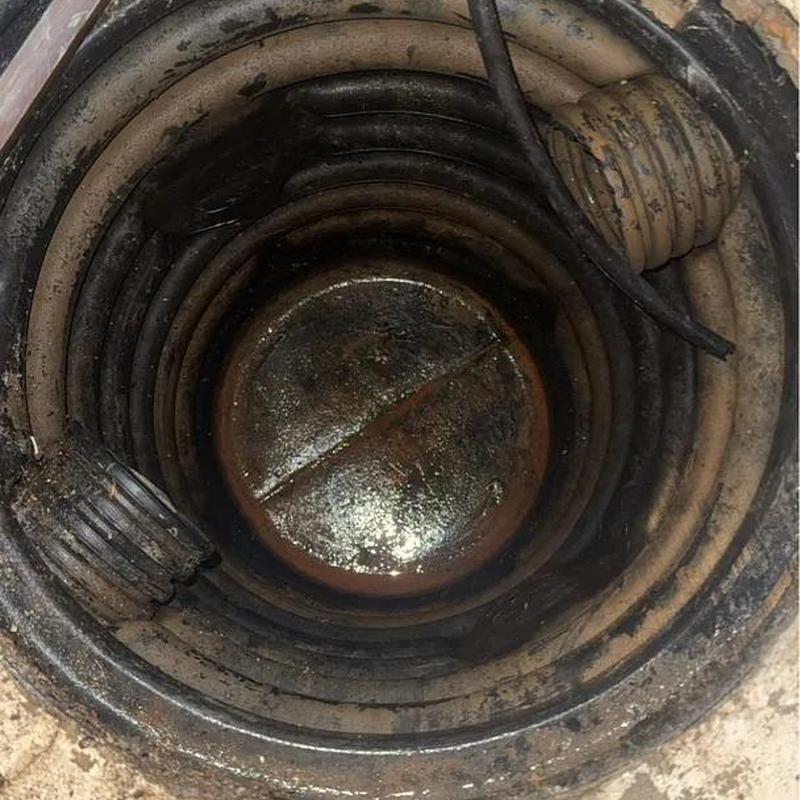 Sump pump basket and corroded metal cover inside pit