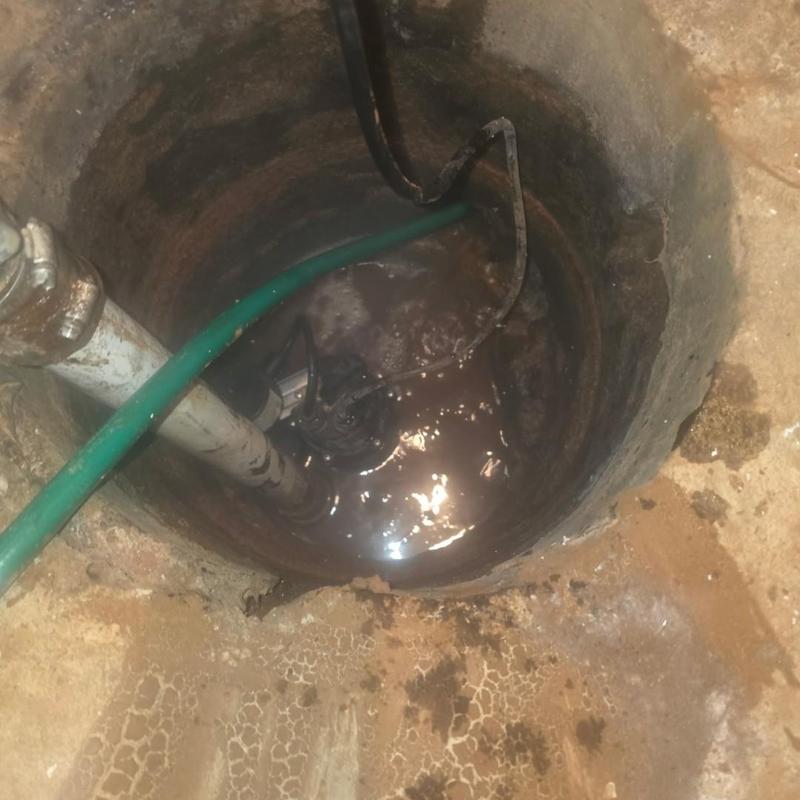 Sump pump basin with water and service hoses