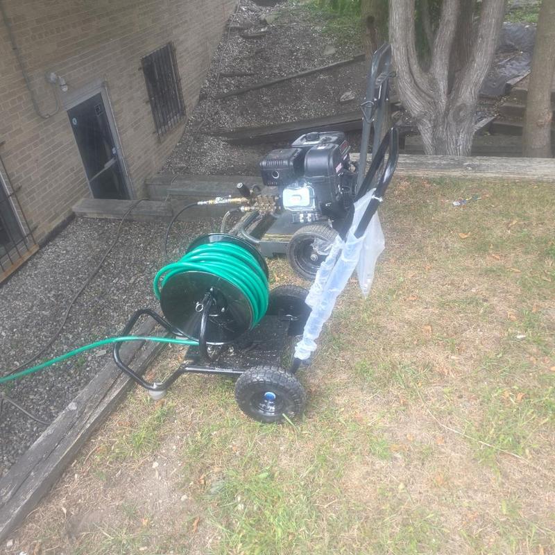 Drain tile hydro jetting machine on grassy yard