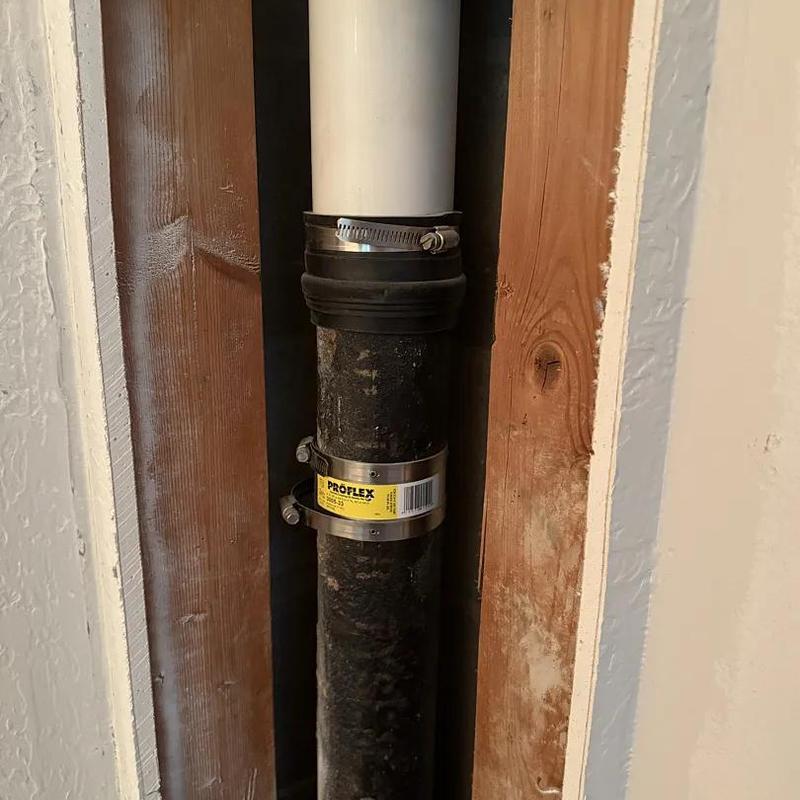 PVC and cast iron plumbing pipe with coupler clamps