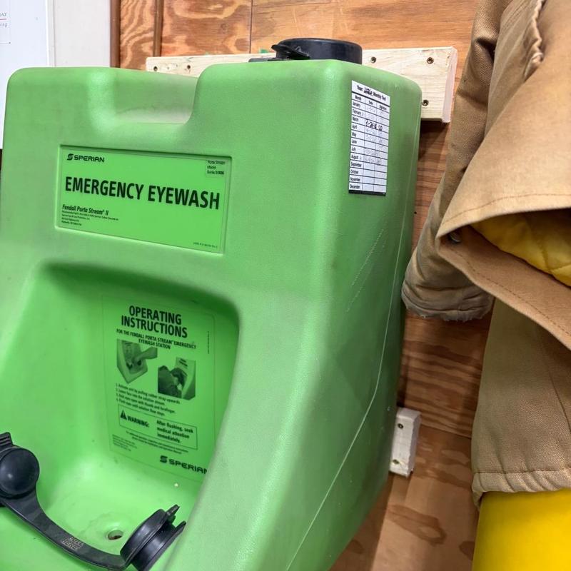 Emergency eyewash station rehung on wood panel