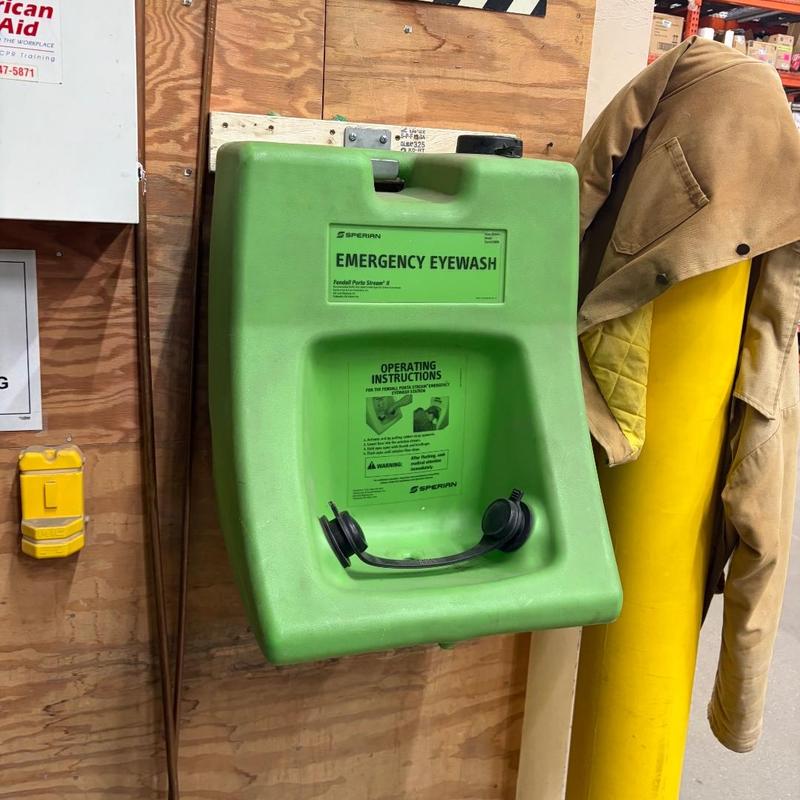 Emergency eyewash station rehung on wood wall