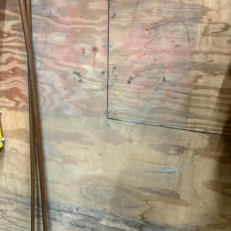 Eyewash station rehung on plywood wall