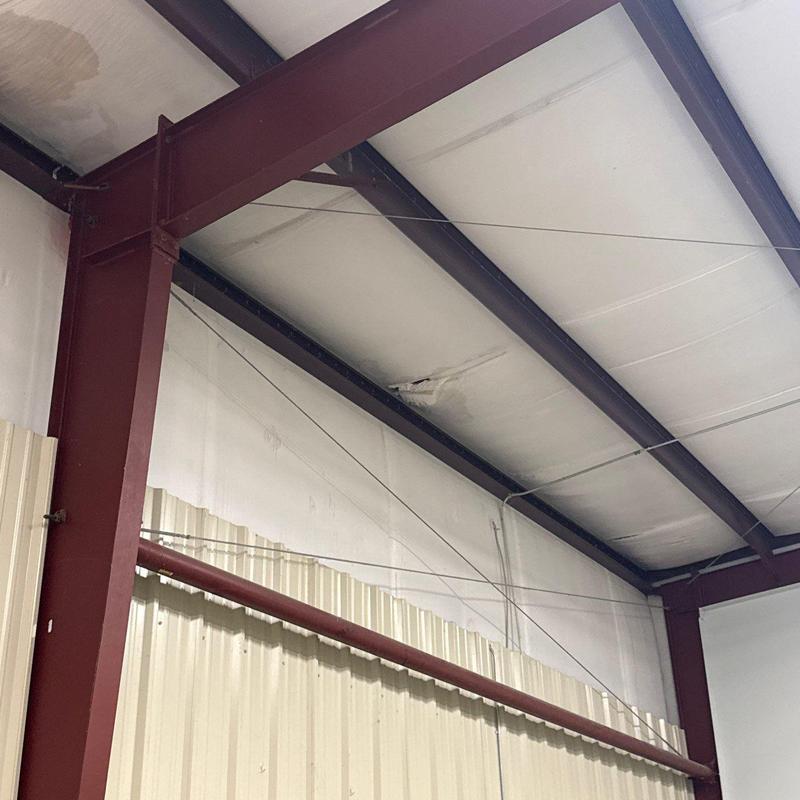 Insulated metal ceiling panel with water damage stain