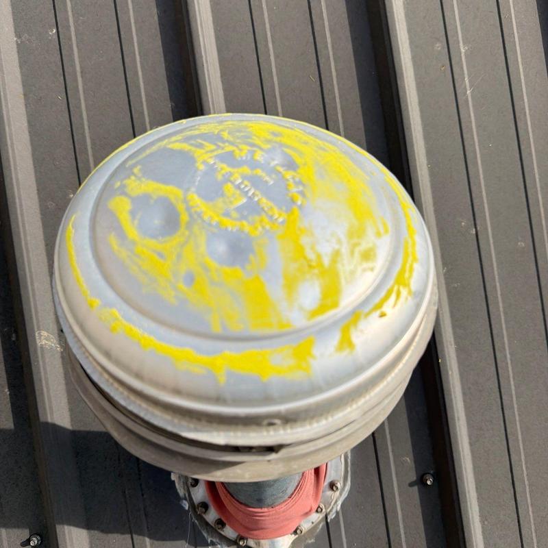 Metal roof vent with hail damage markings