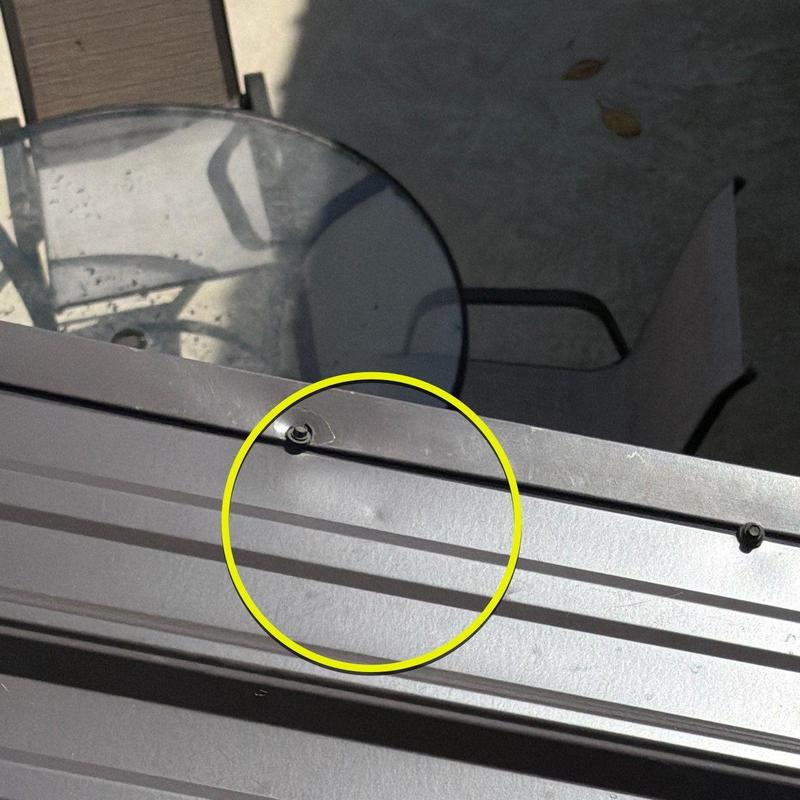 Metal roof panel showing slight hail damage dent