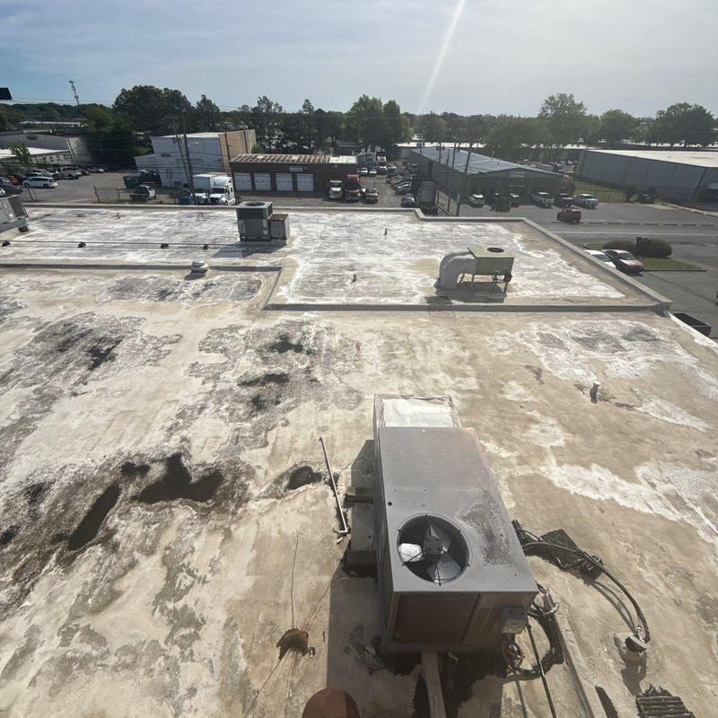 Commercial flat roof with hail damage patches