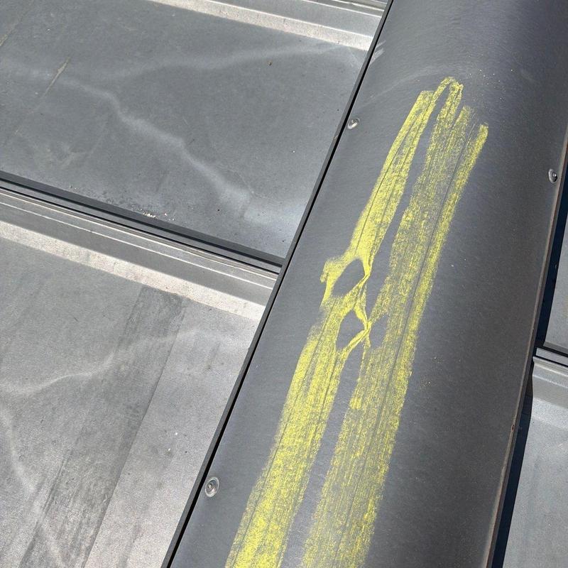 Roof ridge panel with yellow chalk damage markings