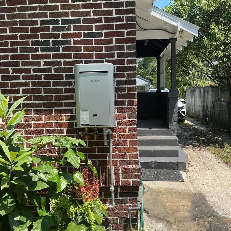 Rinnai tankless water heater mounted on brick wall