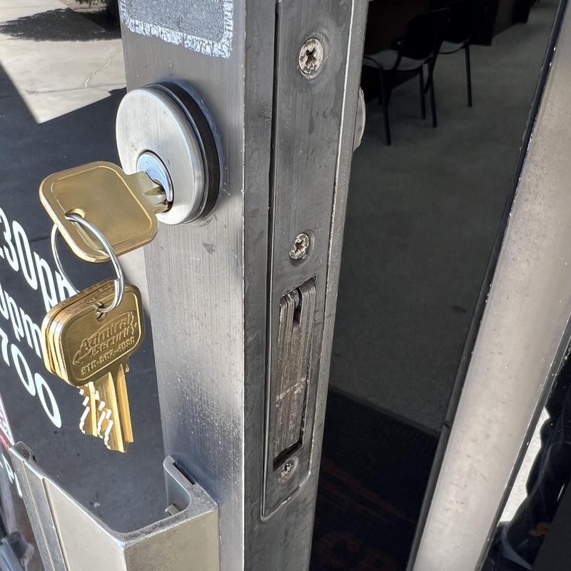 Front door cylinder lock with key inserted and keyring Front door cylinder lock with key inserted and keyring