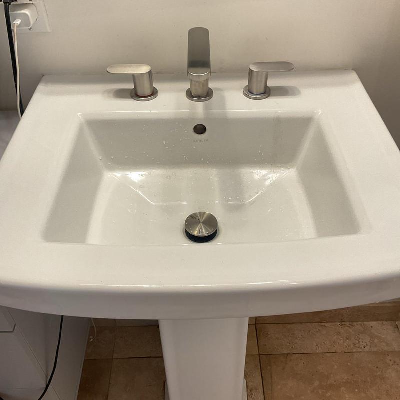 Lavatory faucet on white pedestal sink in bathroom Lavatory faucet on white pedestal sink in bathroom