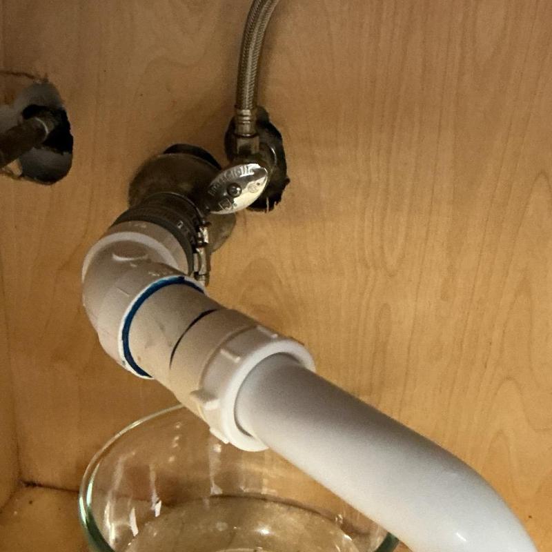 PVC drain pipe and supply line under sink with valve adjustments