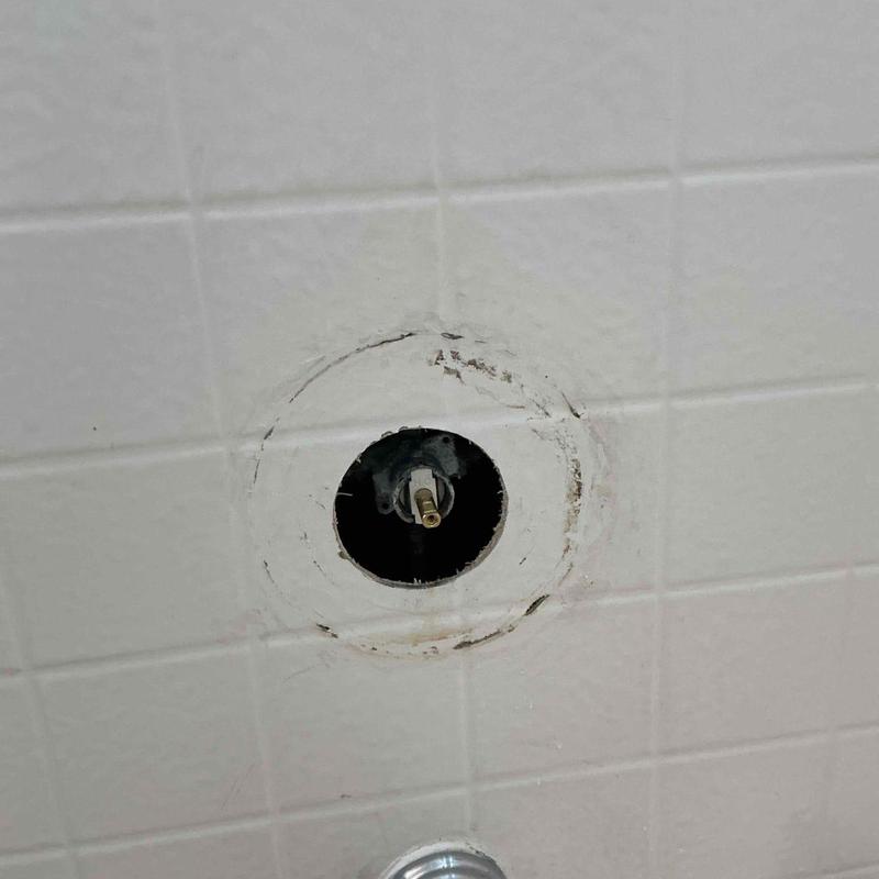 Shower valve cartridge housing in tiled wall opening