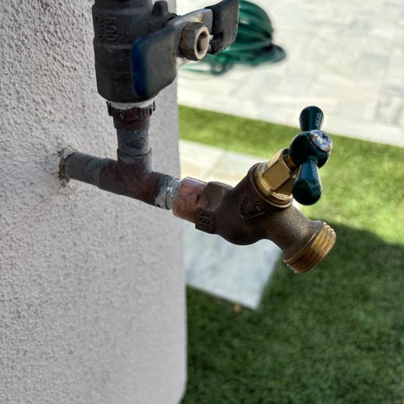 Hose bib with new valve installed on exterior wall