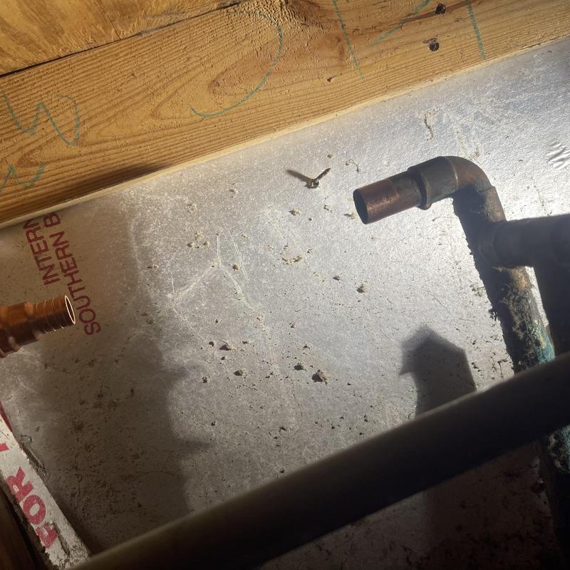 Copper plumbing pipe joint and fittings in crawl space Copper plumbing pipe joint and fittings in crawl space
