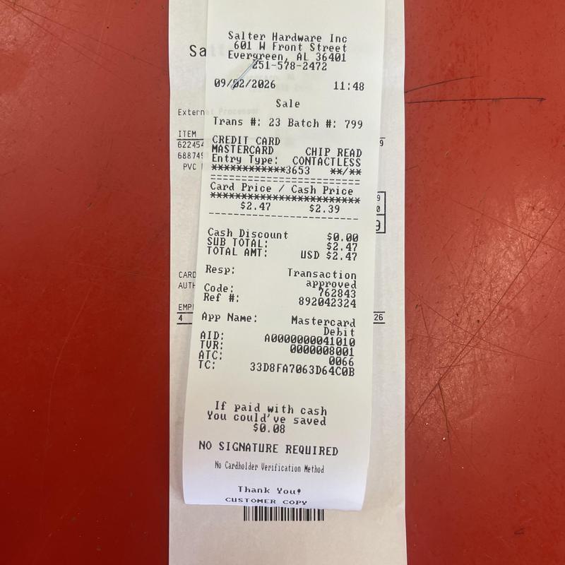 Hardware store purchase receipt on red counter Hardware store purchase receipt on red counter