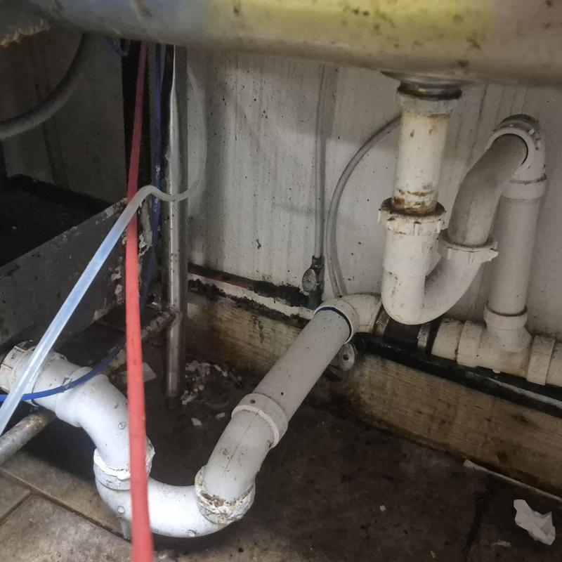 Kitchen sink PVC drain pipes with corrosion and leak signs Kitchen sink PVC drain pipes with corrosion and leak signs