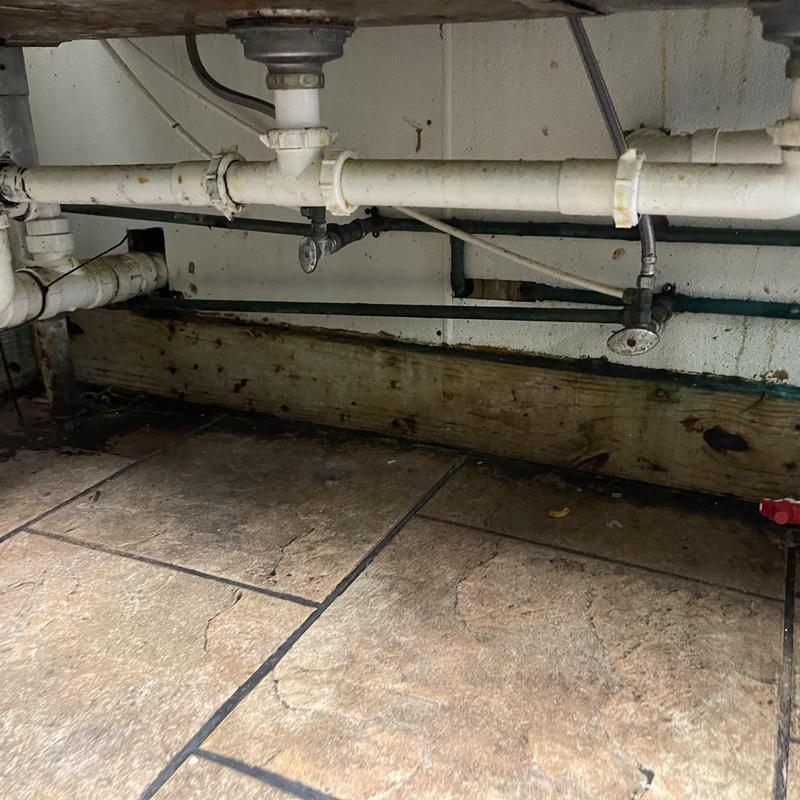 Kitchen sink drain pipes with visible corrosion and rust Kitchen sink drain pipes with visible corrosion and rust