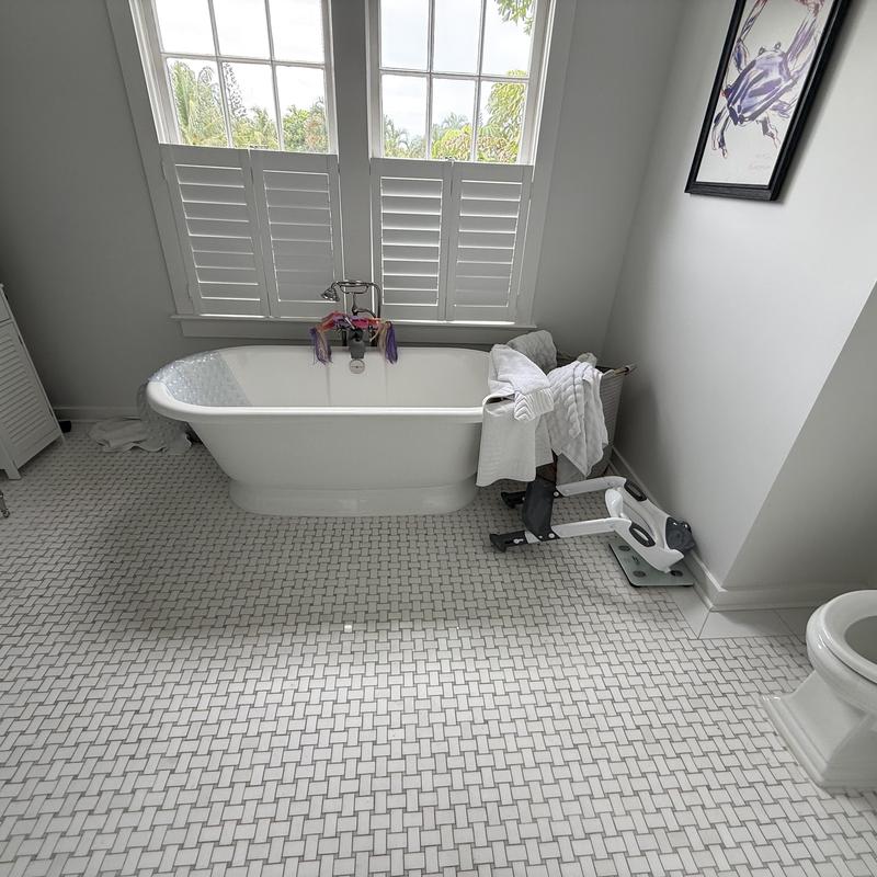 Freestanding bathtub and floor tile in bathroom