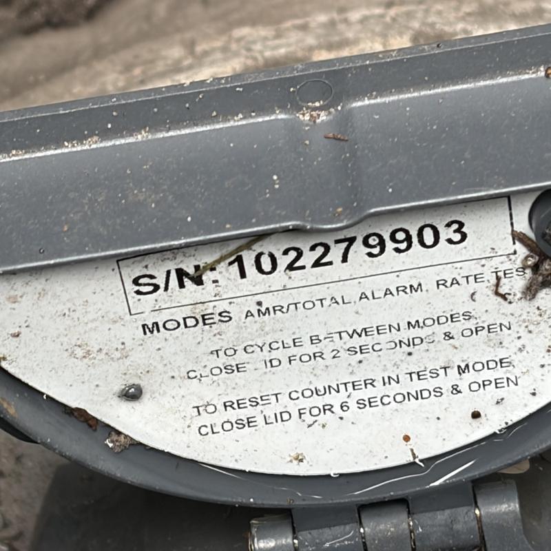 Water meter serial number label close-up with test instructions Water meter serial number label close-up with test instructions