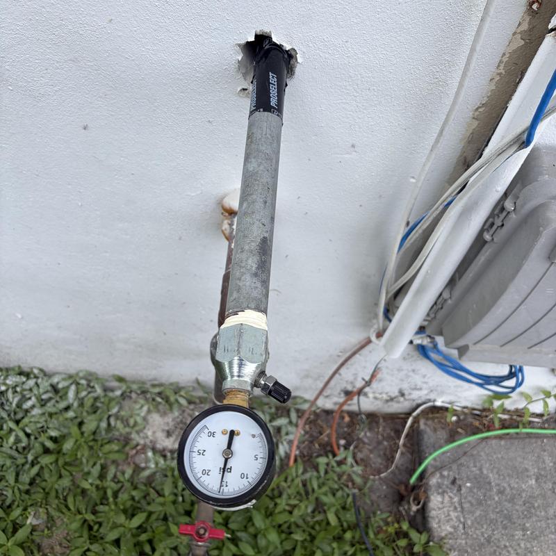 Gas pressure gauge on outdoor pipe with valve