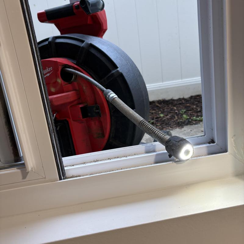 Drain cleaning jetter hose with inspection light at window Drain cleaning jetter hose with inspection light at window