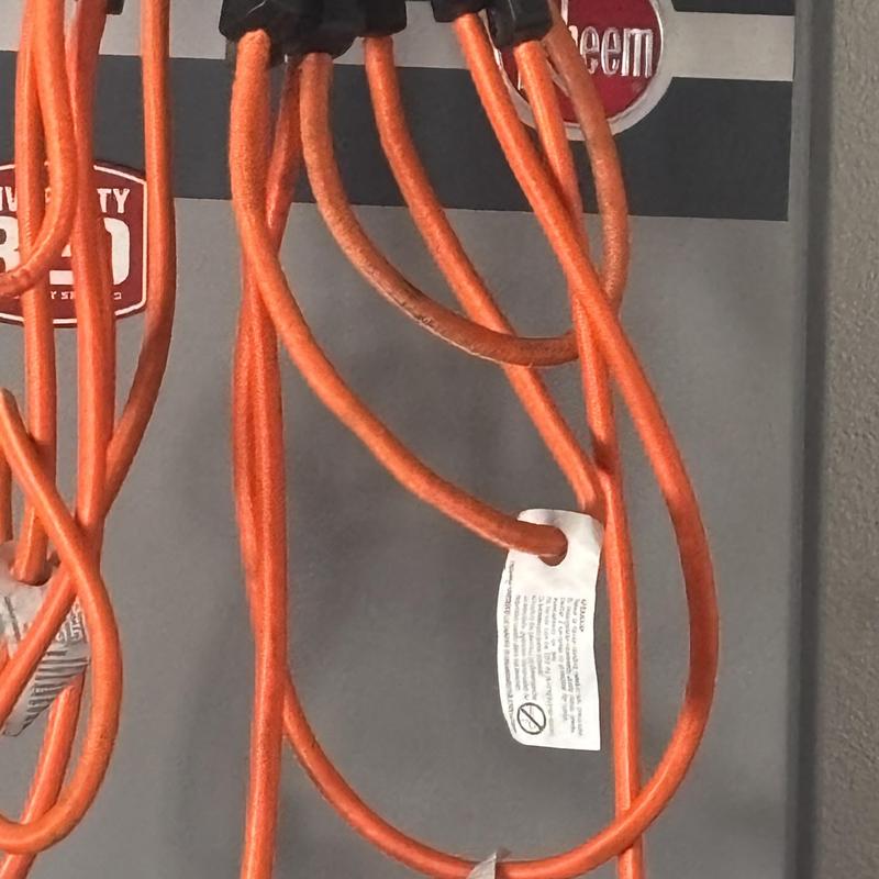 Orange gas manifold hoses connected to tank system Orange gas manifold hoses connected to tank system