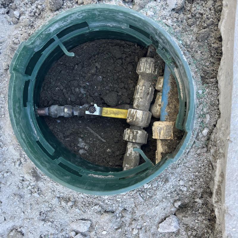 Pool valve assembly in valve box with dirt and pipes Pool valve assembly in valve box with dirt and pipes
