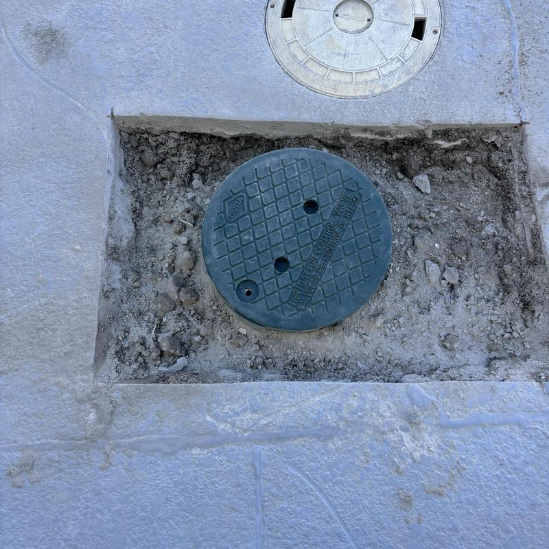 Pool valve cover set in concrete patch Pool valve cover set in concrete patch