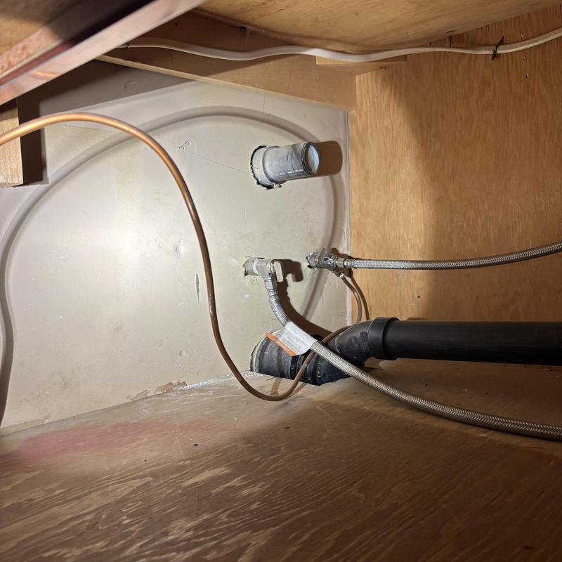 Toilet tank plumbing with supply lines and drain pipes Toilet tank plumbing with supply lines and drain pipes