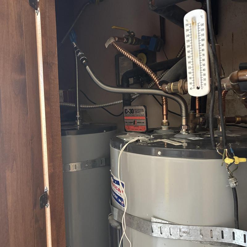 Water heater supply line with temperature gauge and pipes Water heater supply line with temperature gauge and pipes