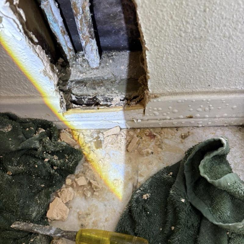 Water supply pipes in wall cavity with debris and tools Water supply pipes in wall cavity with debris and tools