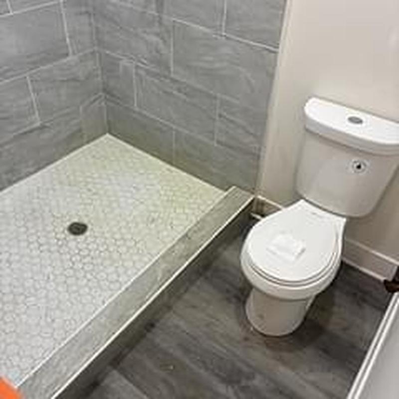Toilet base leak repair with shower head assembly