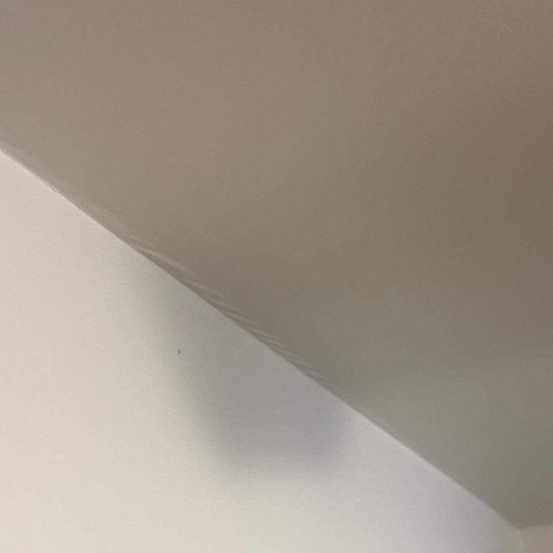 Ceiling corner with visible water stain and discoloration