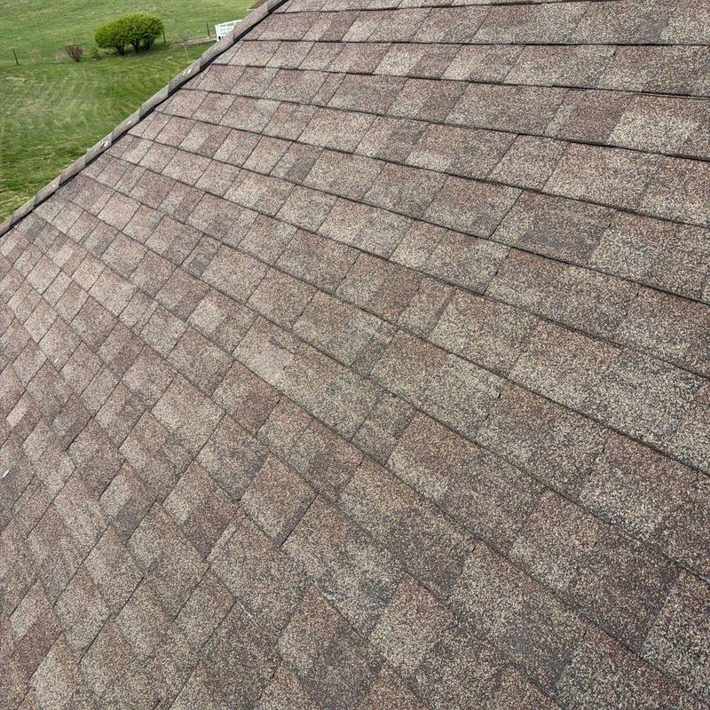 Asphalt shingle roof with hail damage inspection