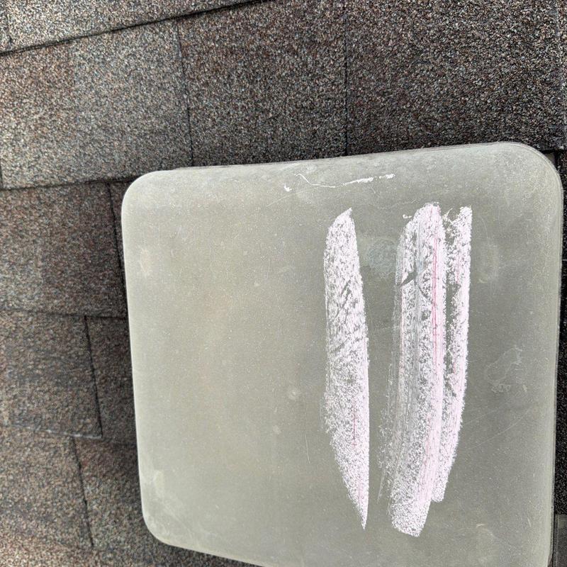 Roof vent cover with chalk markings on shingles
