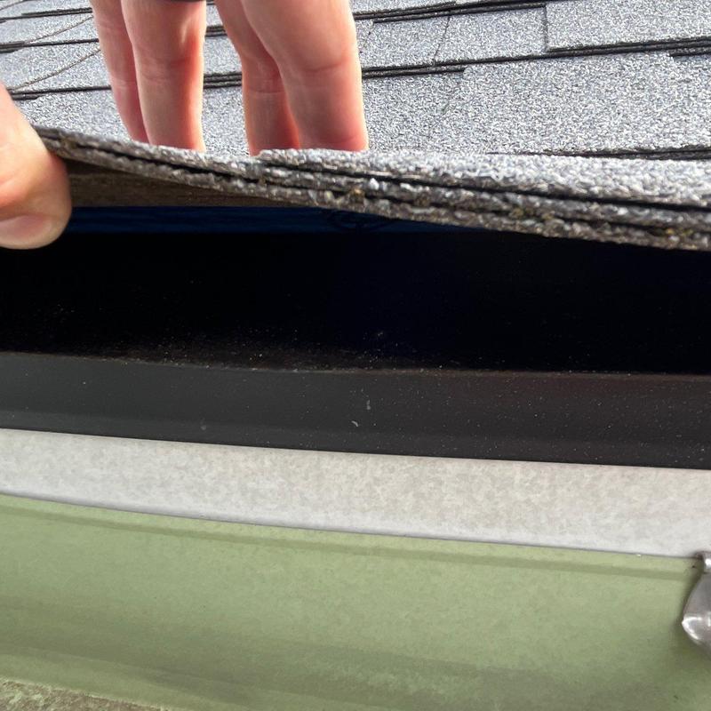 Roof shingles lifting for hail damage inspection