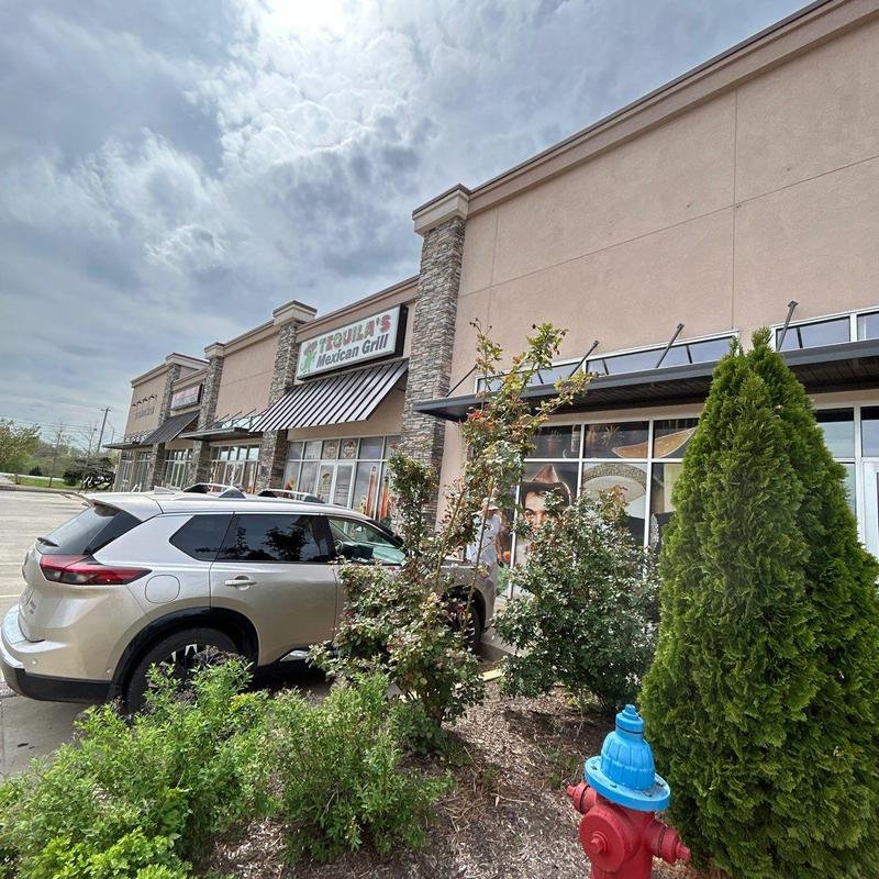 Commercial store awning inspection with vehicle nearby