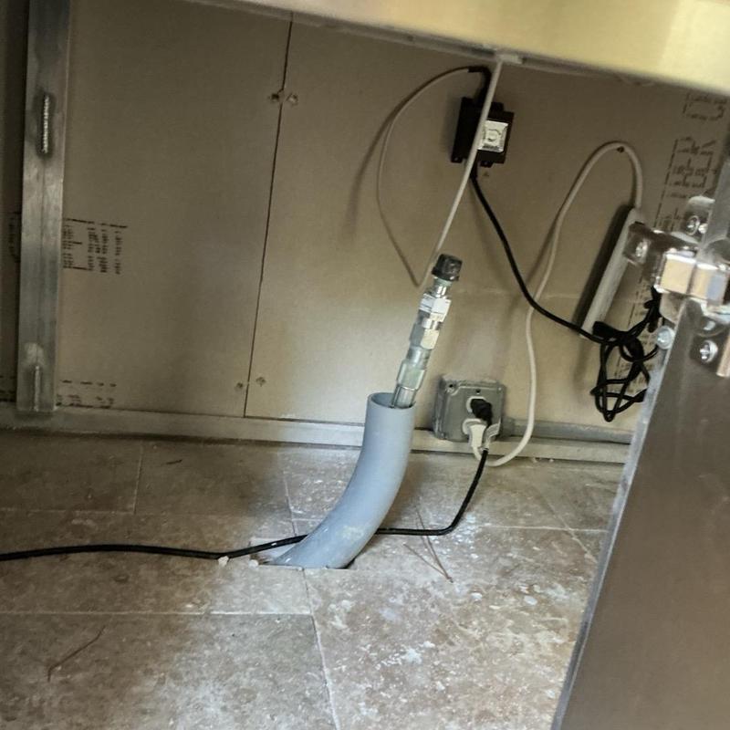 Outdoor gas grill supply line installation under counter