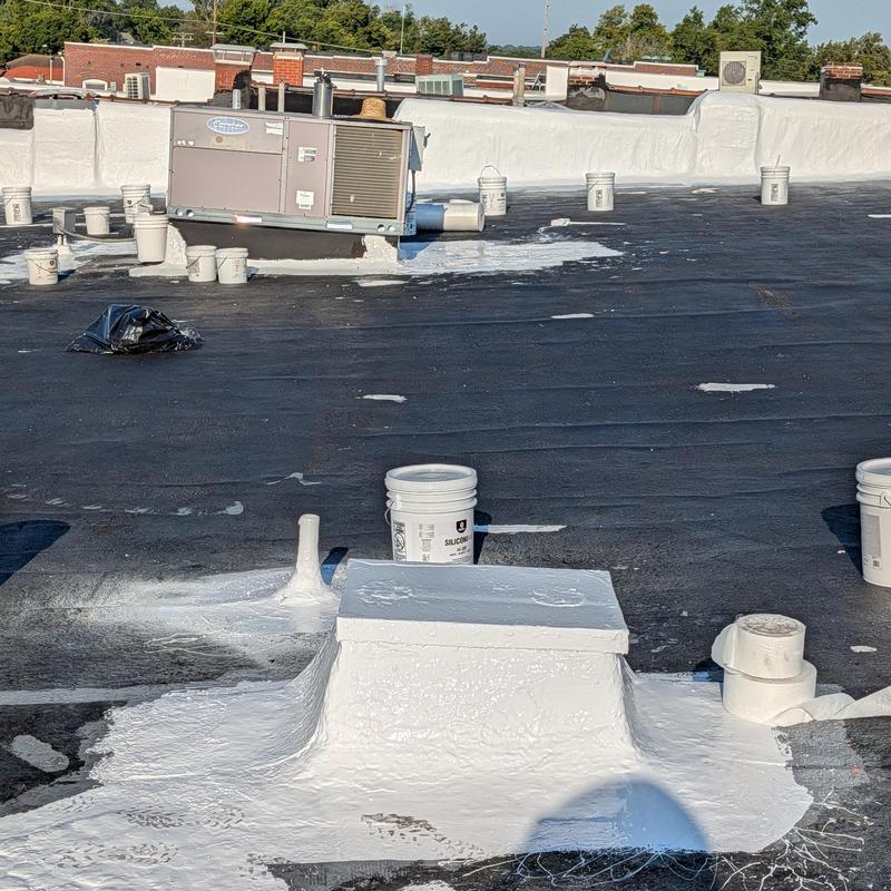 Parapet walls elastomeric top coat application on roof