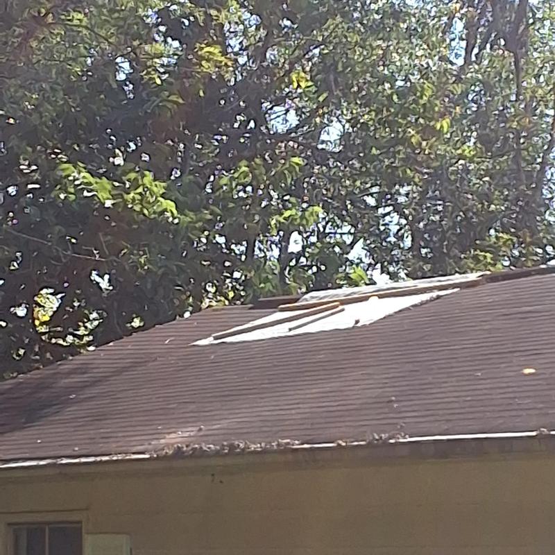 Roof shingles with damaged and missing sections Roof shingles with damaged and missing sections