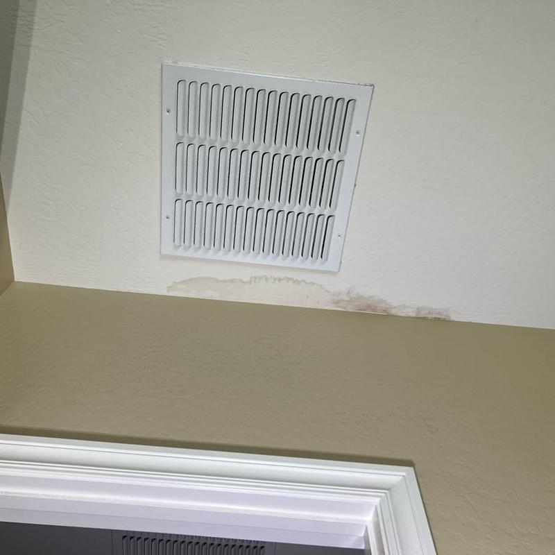 Ceiling air vent with water damage stains