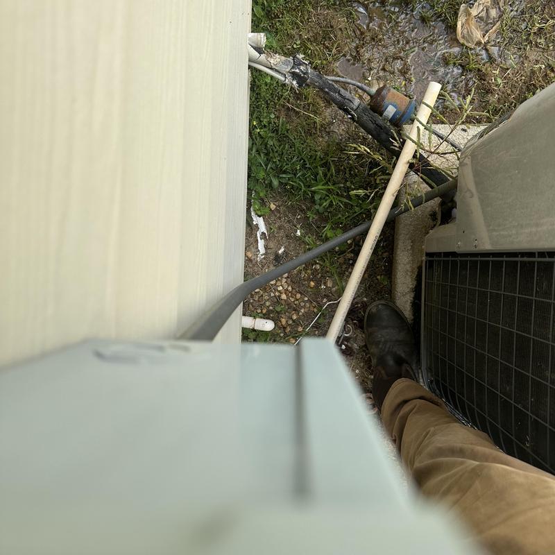 Drain line cleaning near outdoor HVAC unit Drain line cleaning near outdoor HVAC unit